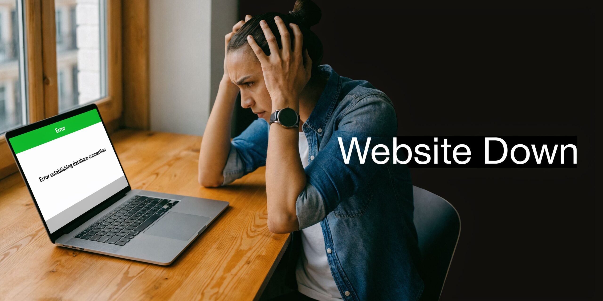 Stressed person sitting at a wooden desk looking at a laptop screen showing an error establishing database connection message.