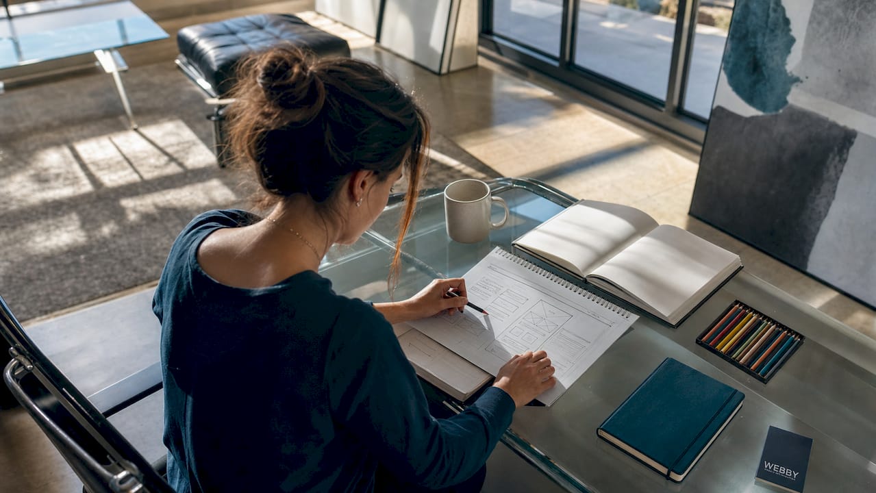 Designer planning contact page layout at desk