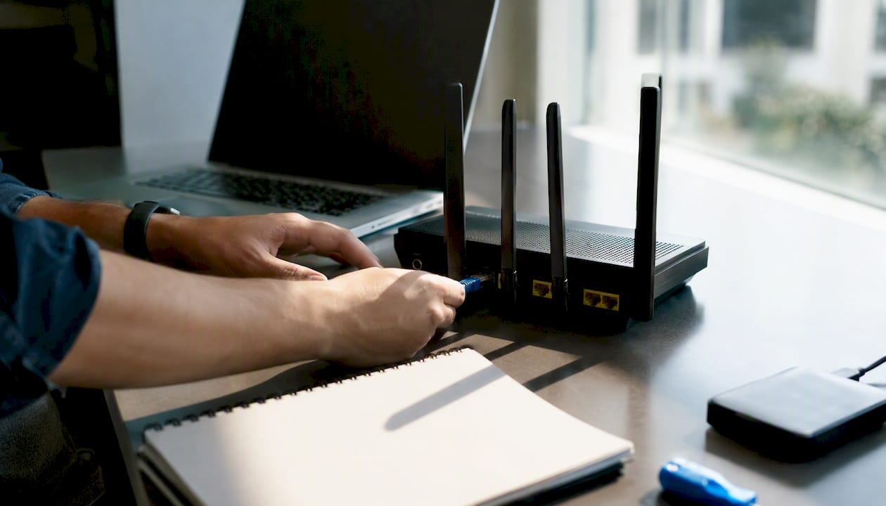 Hands connecting Ethernet cable for SEO audit