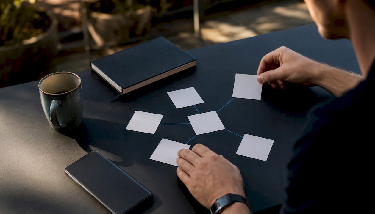 Hands arranging focused blog strategy cluster cards