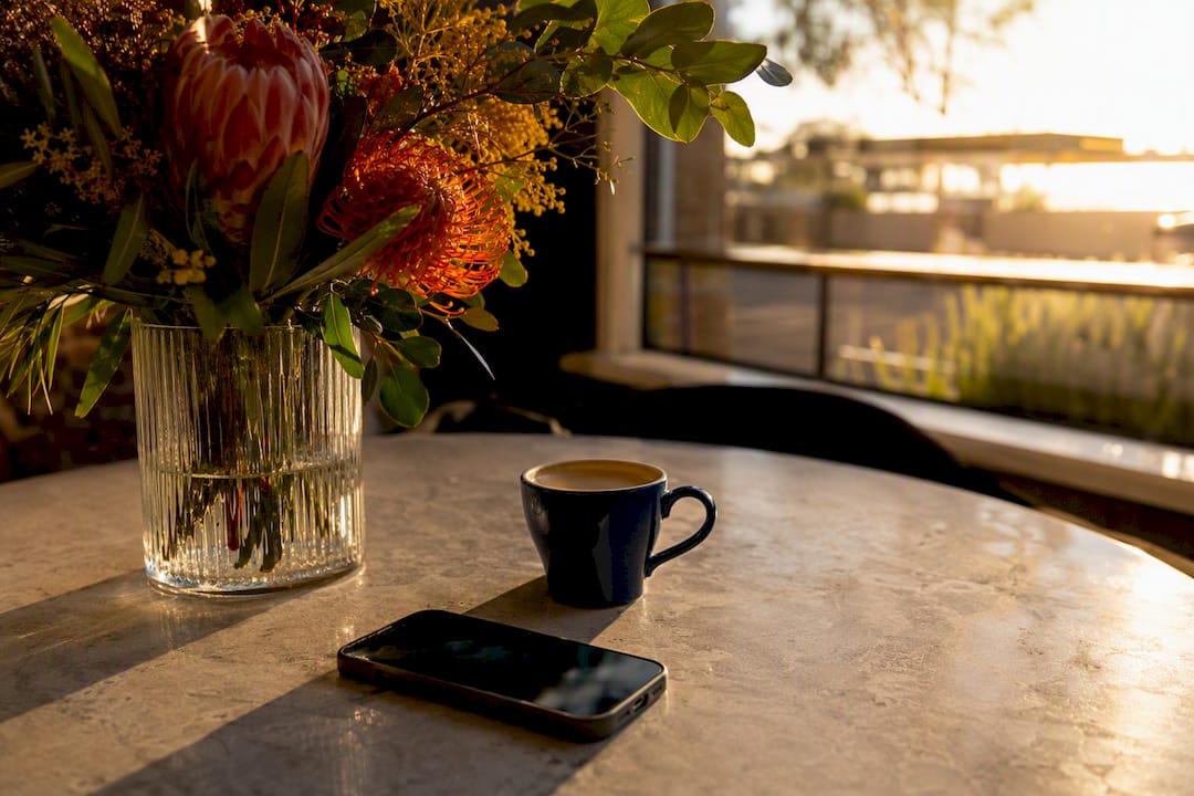 Seasonal coffee cup and flowers on table