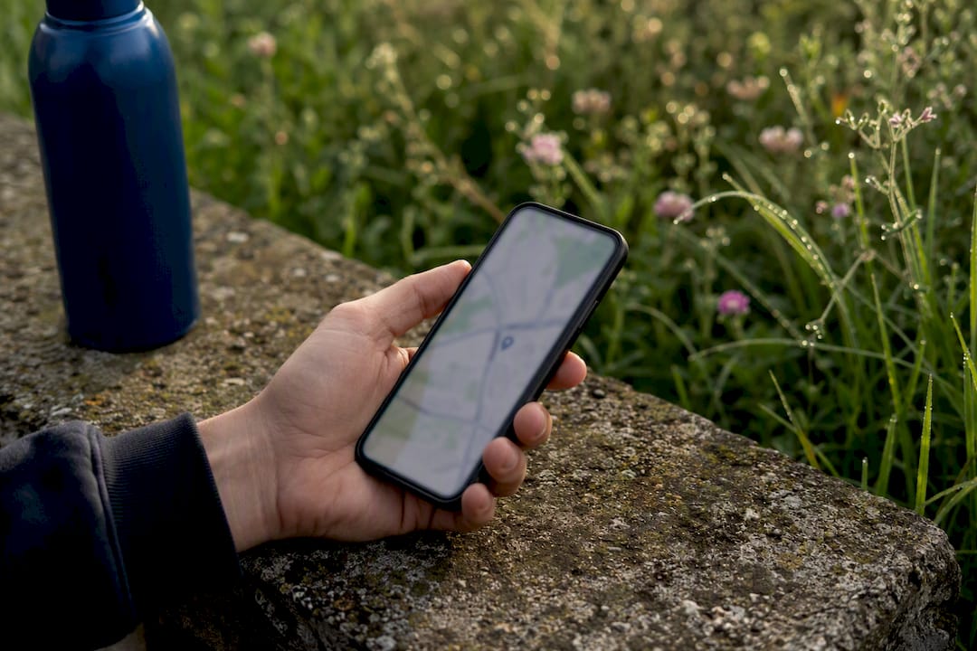 Hand holding smartphone showing local area map