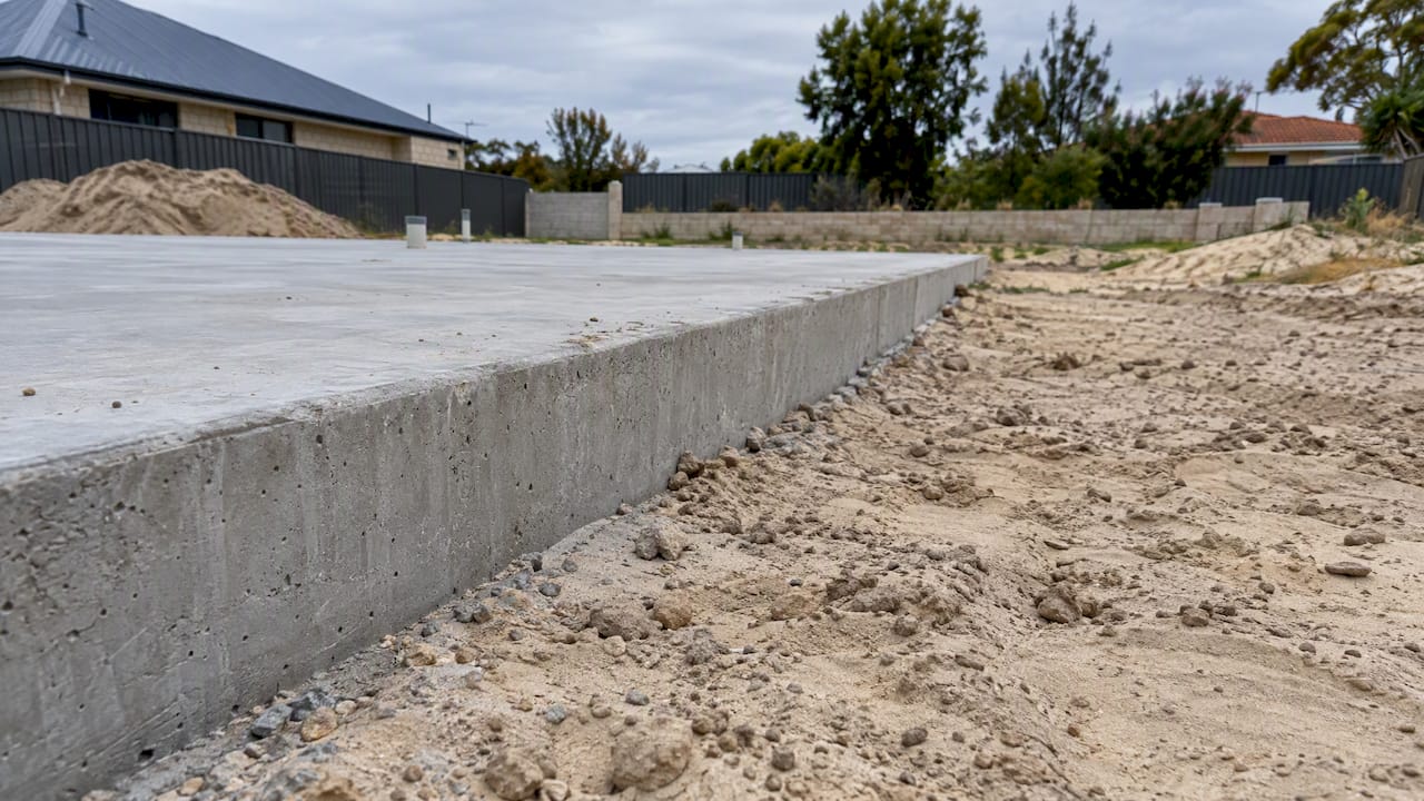 Concrete slab edge beside Perth sandy soil